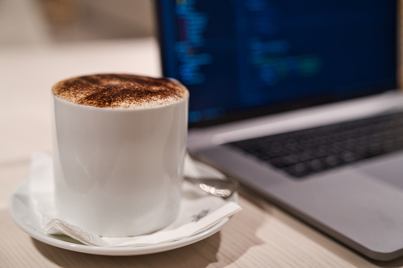 Coffee next to a laptop