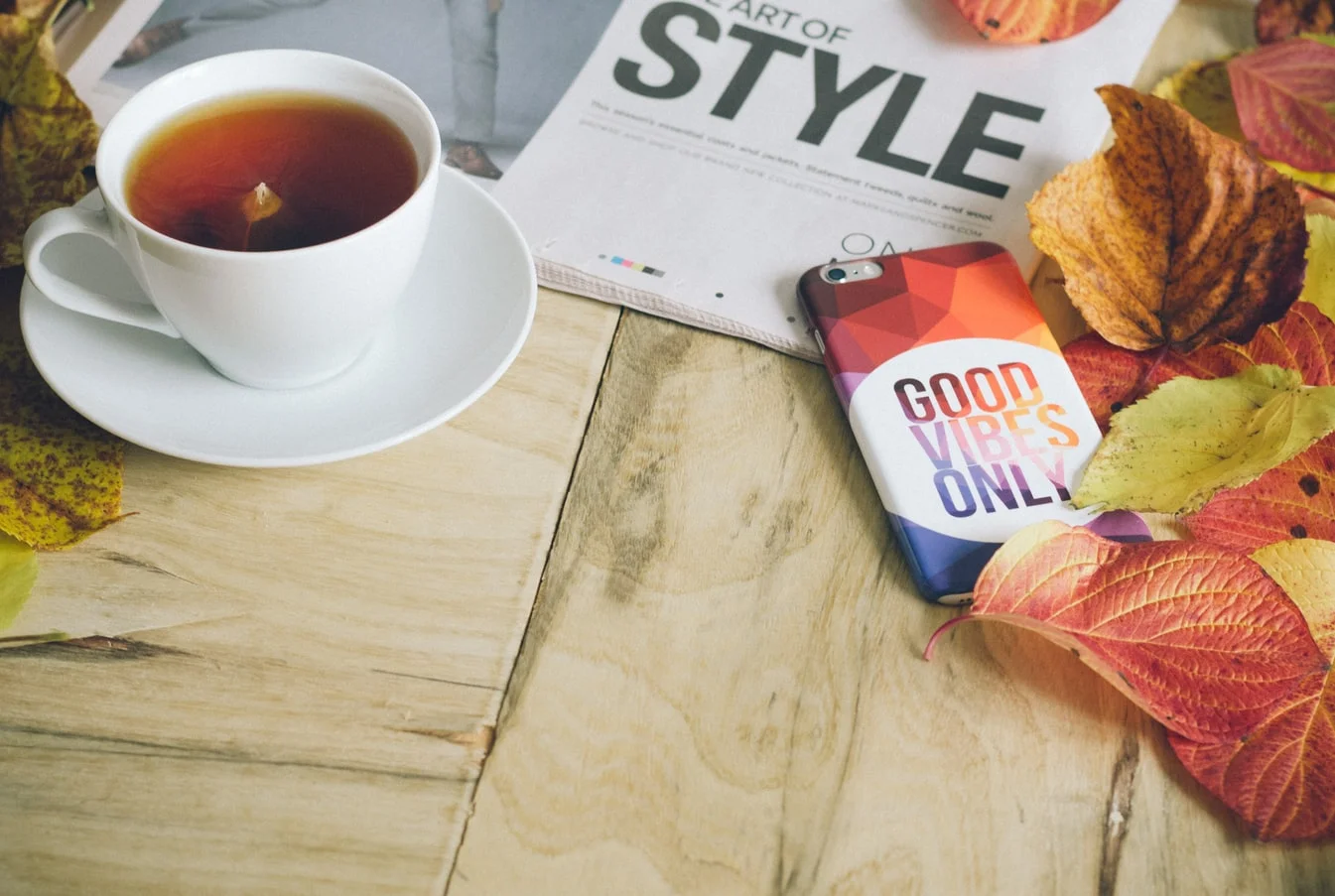 Tea on table with phone and book