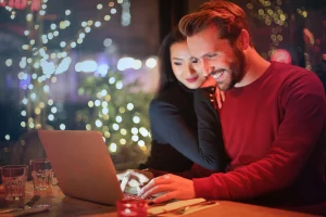 Smiling man and woman on laptop