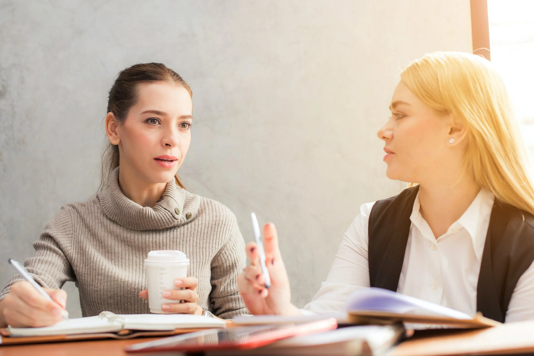 Two women discussing copywriting