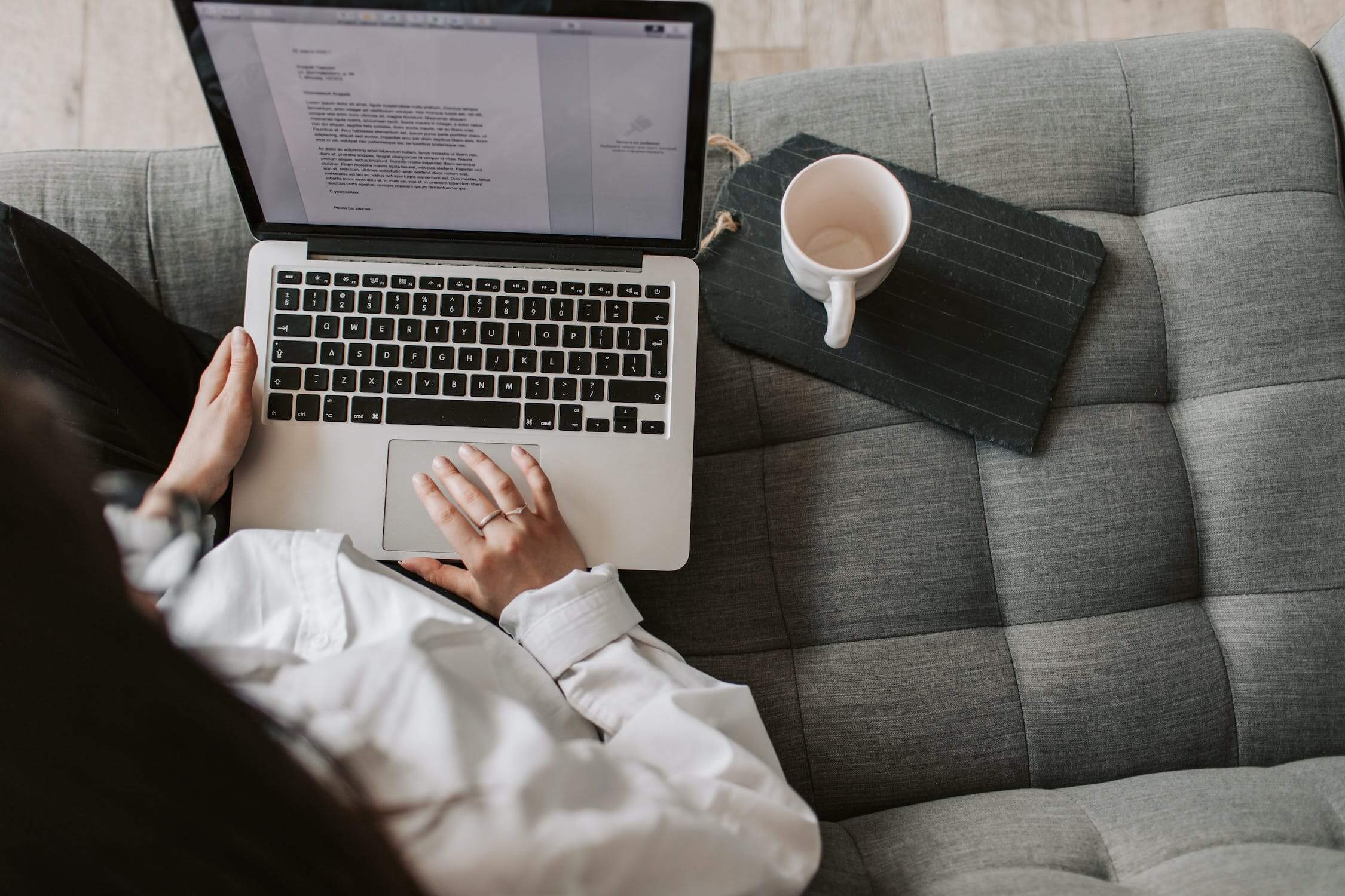 Girl writing on laptop with coffee