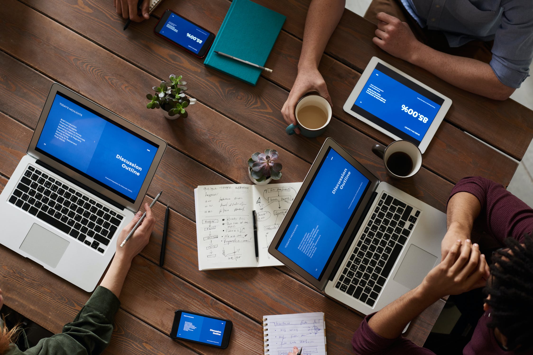 Workers at desk with laptops