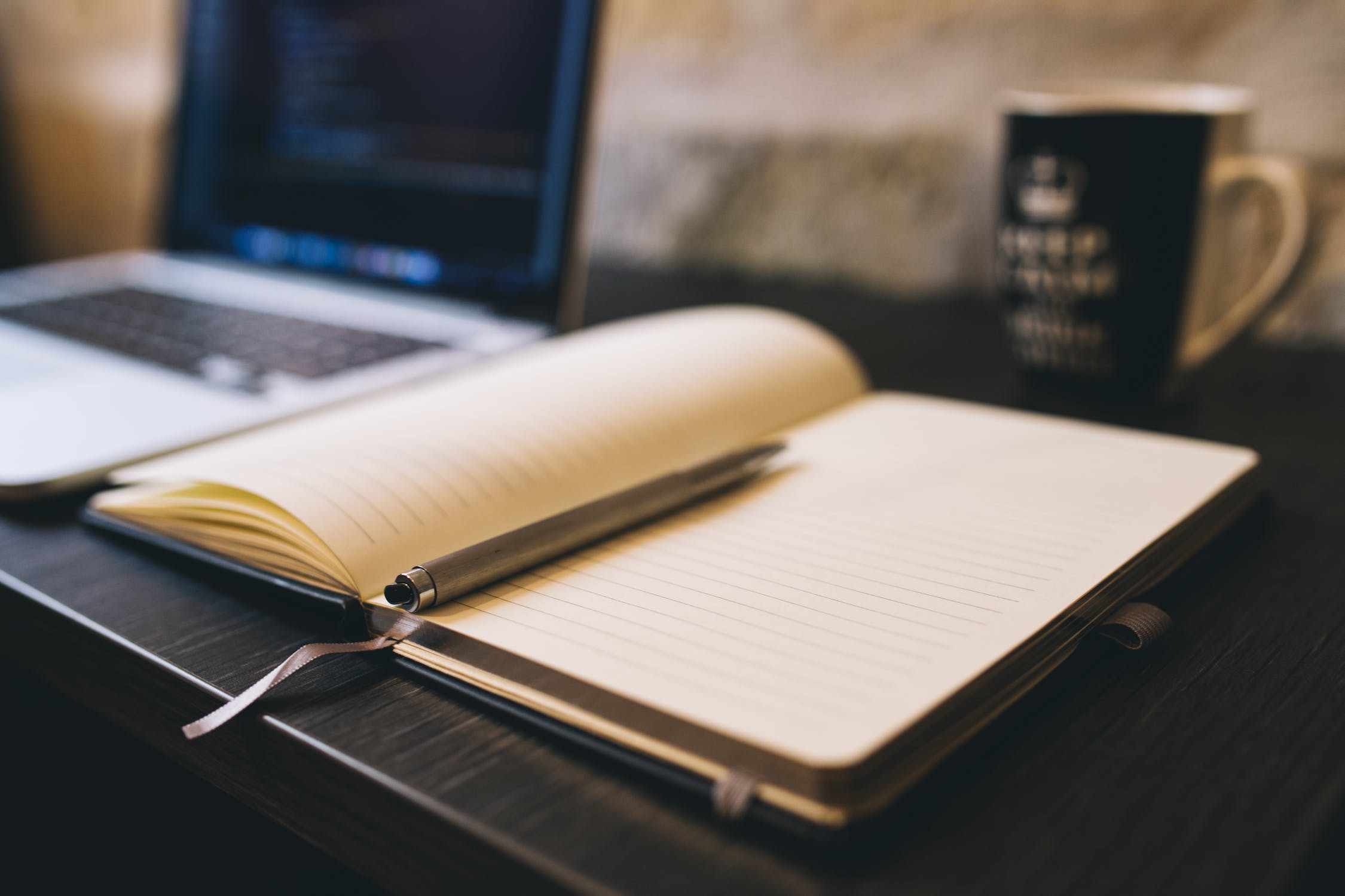 Pen and pad open on desk