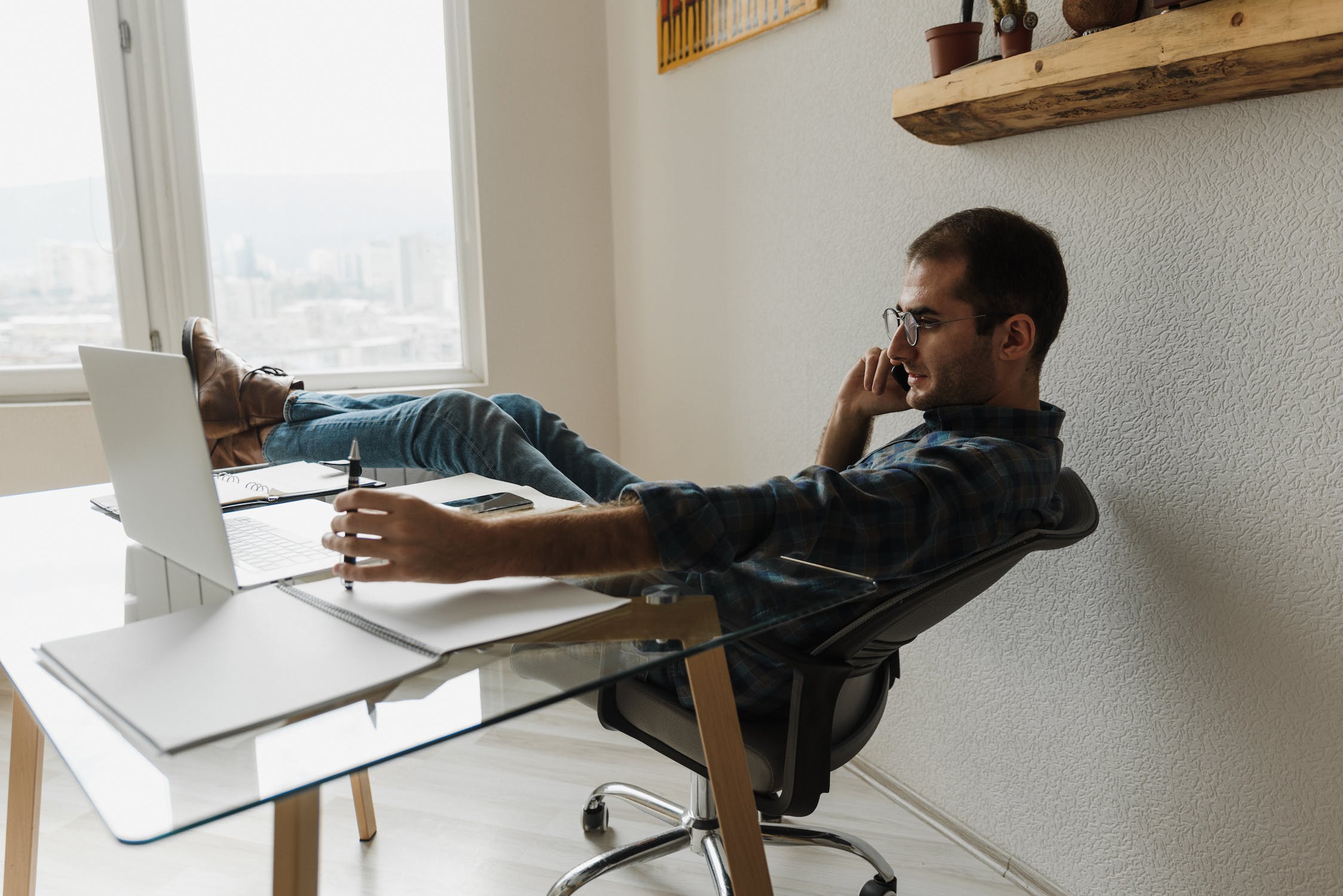 Man at desk sitting back