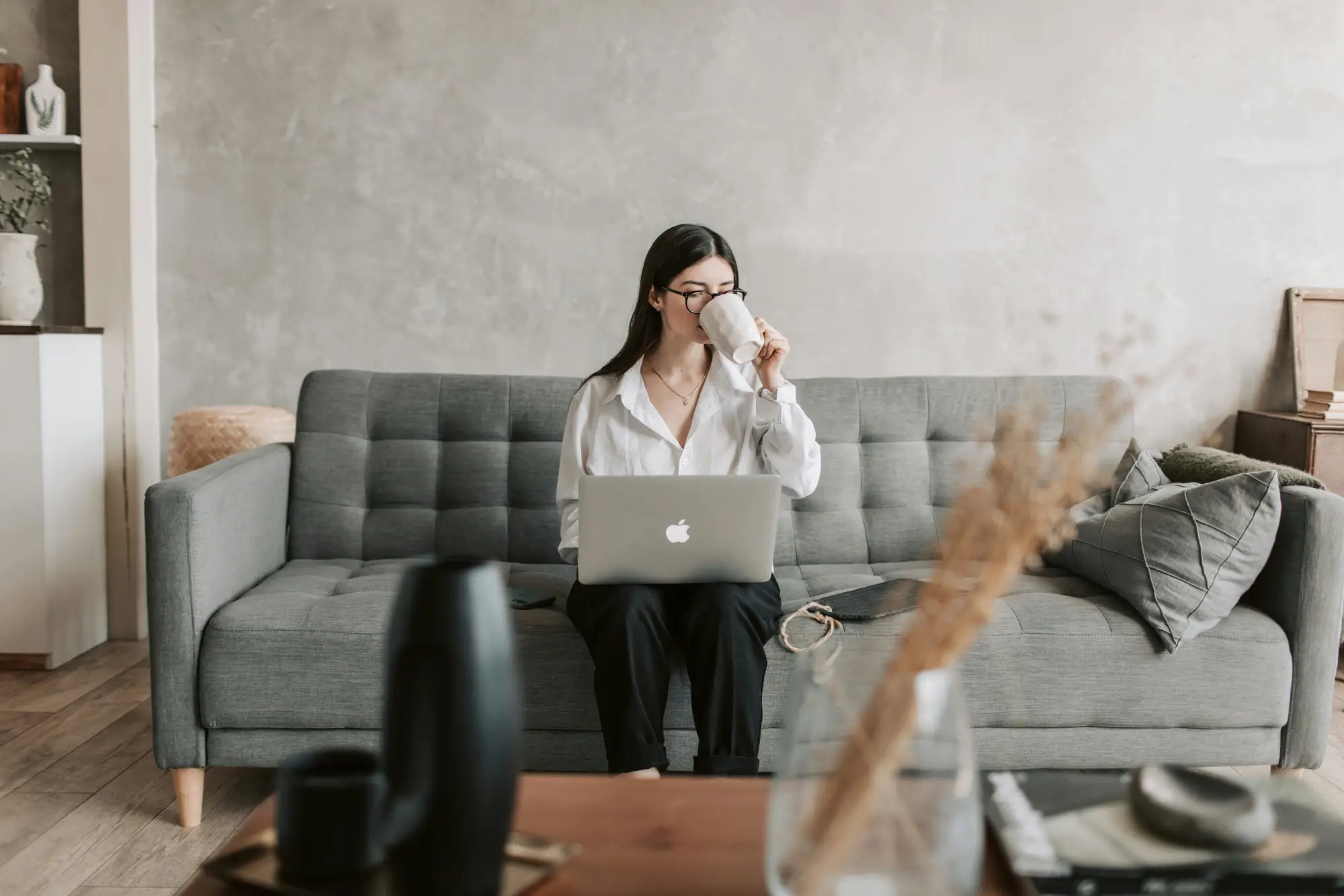 Woman drinking coffee while emailing