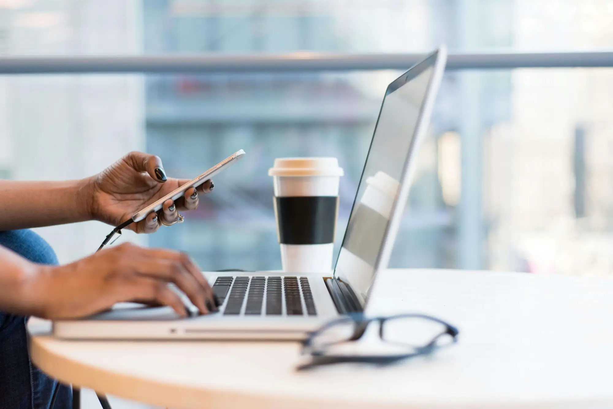 Woman typing and on phone