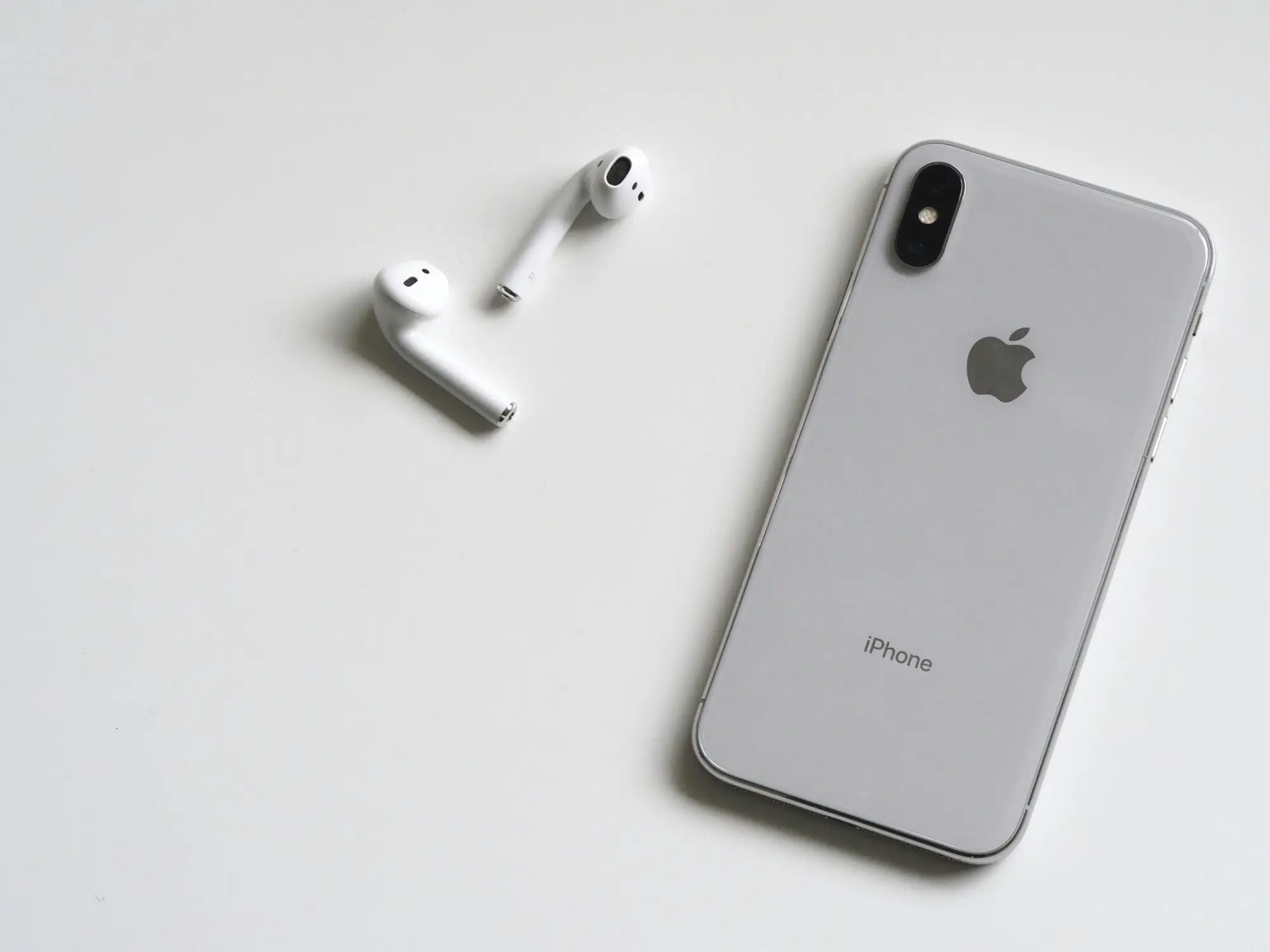 iPhone and Airpods on table