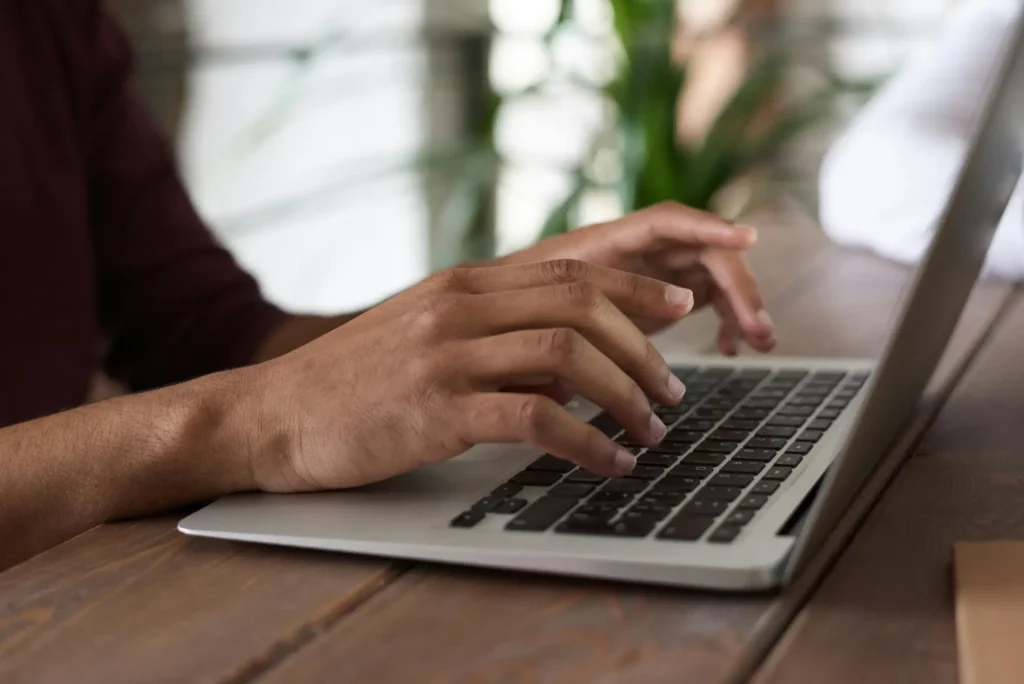 Person writing copy on their laptop