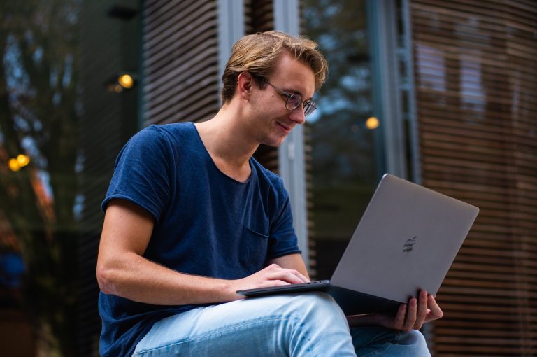 Guy smiling on laptop